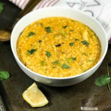 A bowl of wheat khichdi is on the baking tray