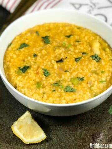 A bowl of wheat khichdi is on the baking tray