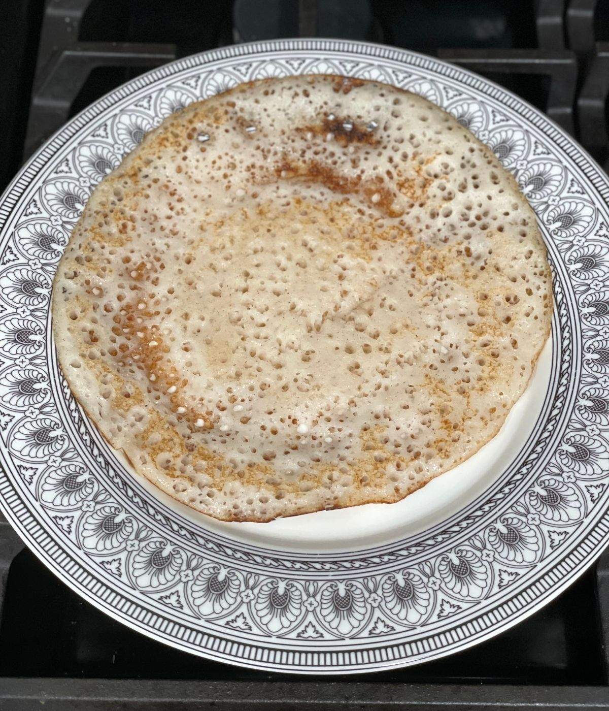 A plate of methi dosa is on the flat surface