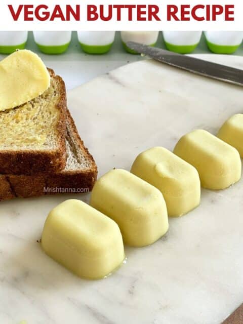 Vegan butter cubes are placed on the white marble tray.
