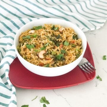 A bowl filled with mint rice on the flat surface