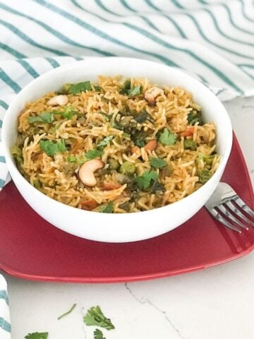 A bowl filled with mint rice on the flat surface