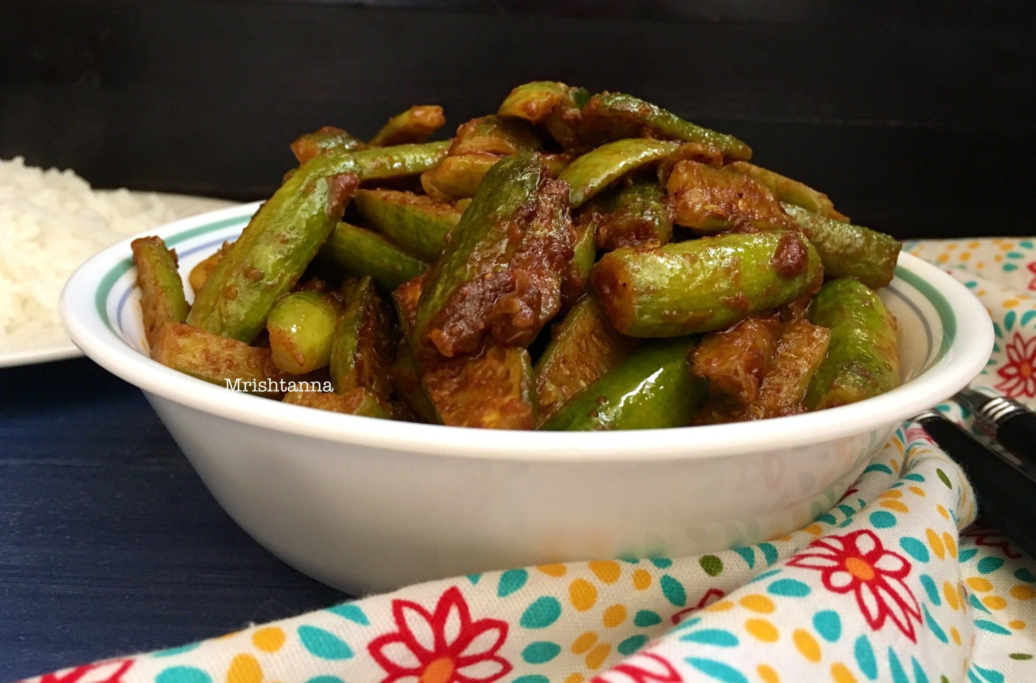 Ivy Gourd Fry - Tindora Fry A bowl of food on a plate, with Ivy gourd and Curry
