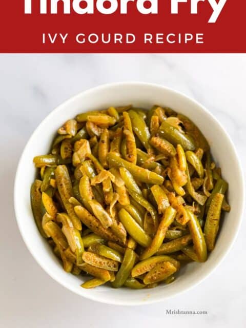 A bowl of ivy gourd fry is on the white surface.