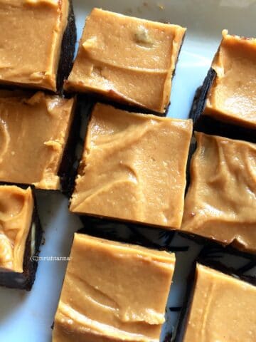 Almond date Fudge is on the white serving tray
