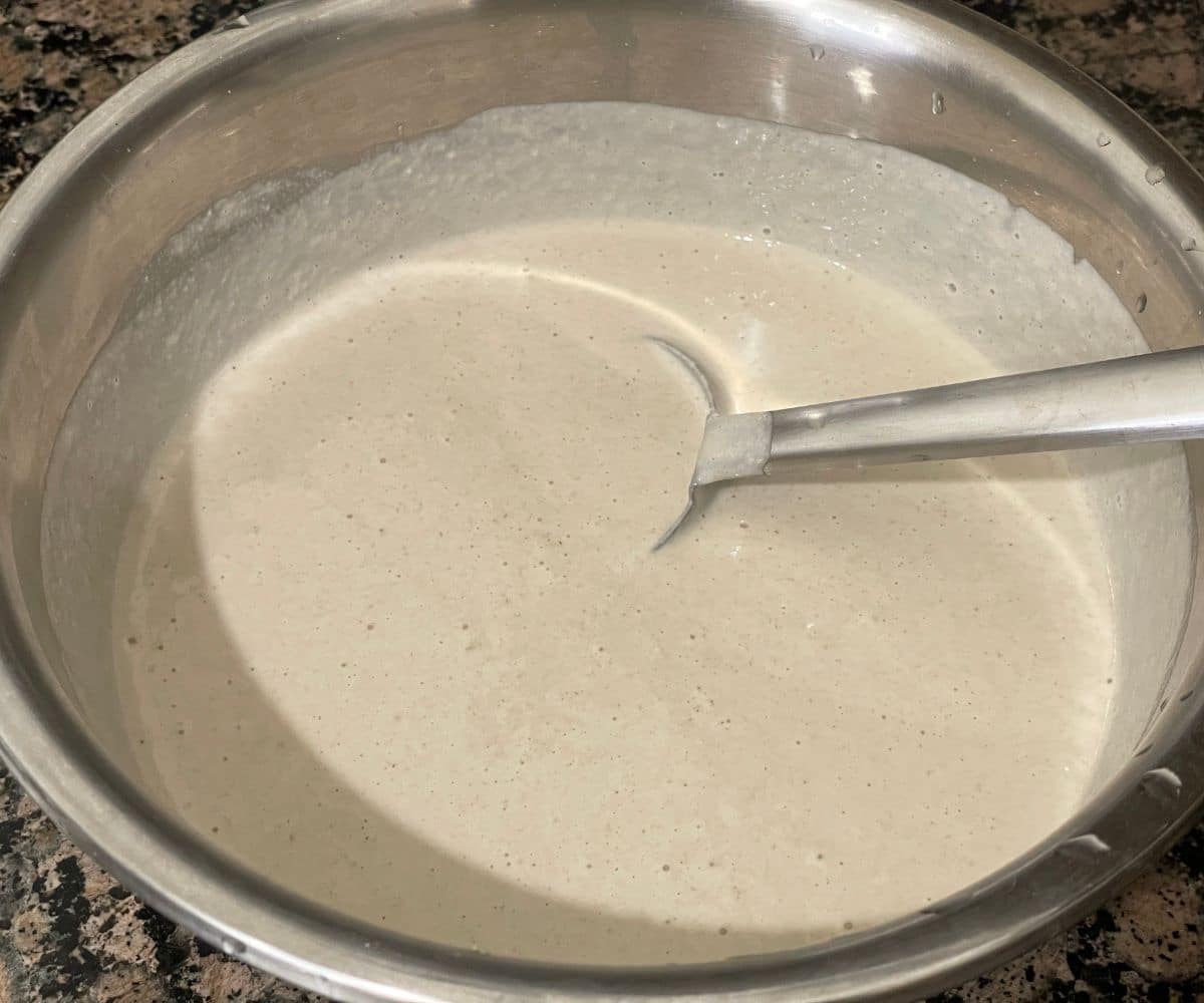 A bowl has quinoa dosa batter.