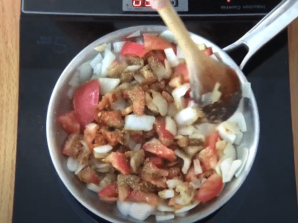 A bowl of food on a table, with Onion and Peanut