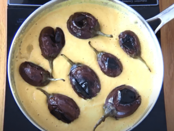 A bowl of food on a plate, with Eggplant and Cook