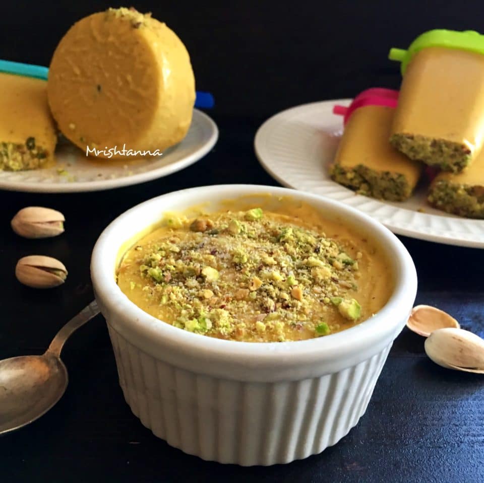 A bowl of food on a table, with Kulfi and Ice cream