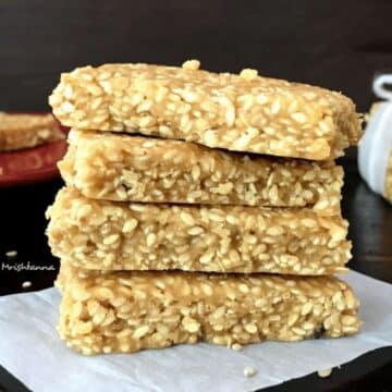 A stack of sesame chikki is on the table.