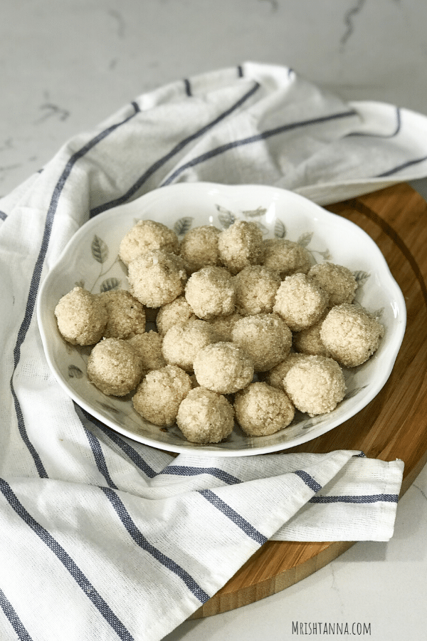 a white plate is full of rava laddu