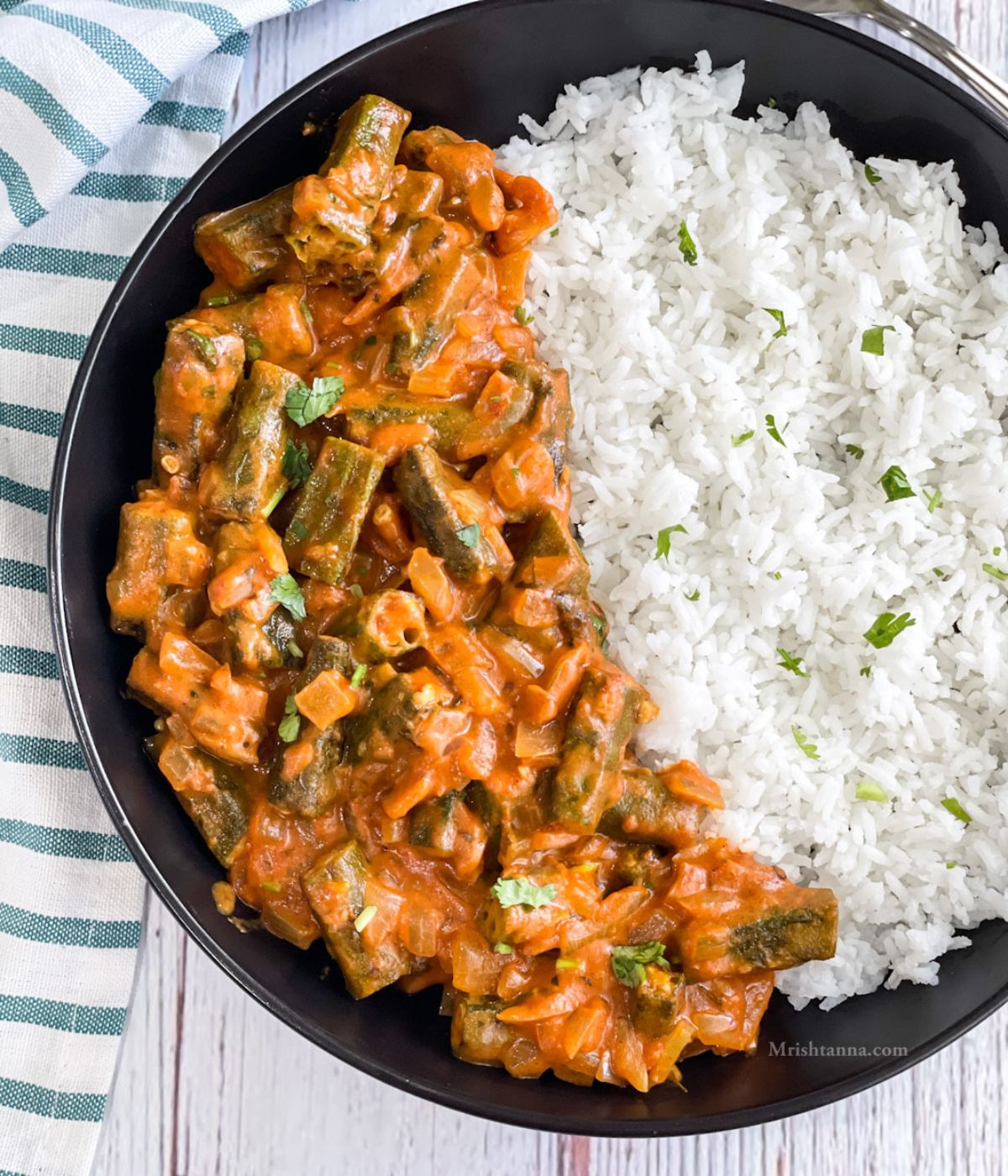 Close up of bhindi masala and rice placed on the plate.