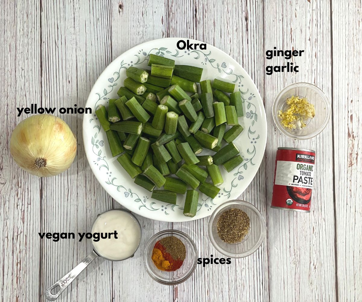A table is with okra curry ingredients.