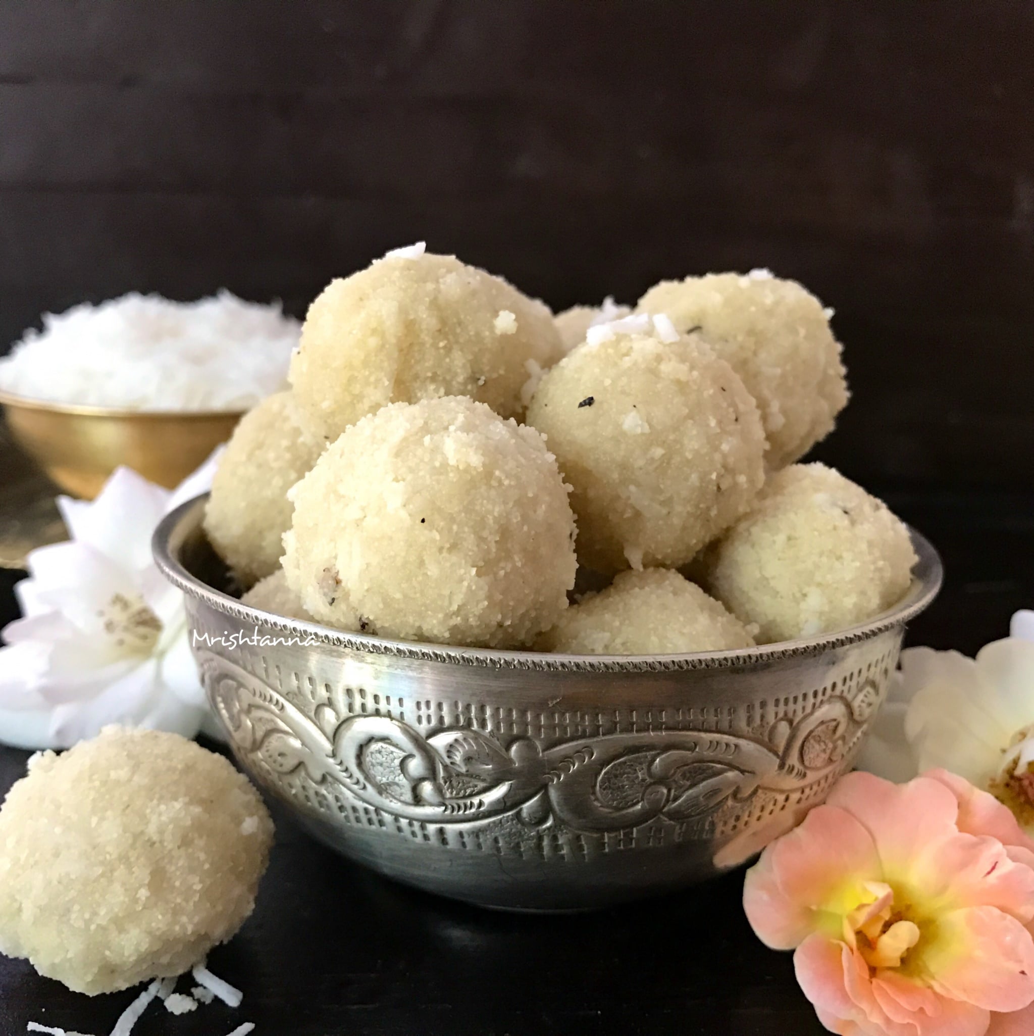 A bowl of food, with Laddu and Coconut