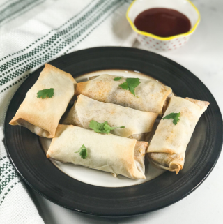 Baked Spring Rolls placed on the black plate