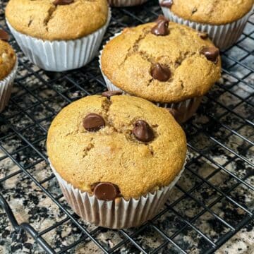 Almond butter banana muffins are on the wire rack.