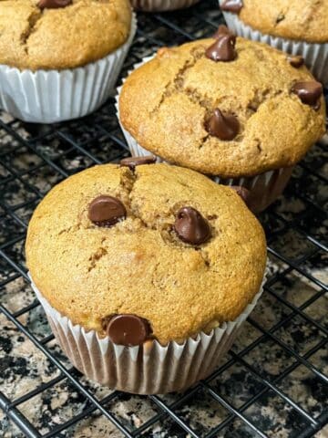 Almond butter banana muffins are on the wire rack.