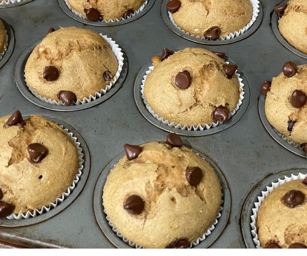 Baked almond butter banana muffins are in the tray.