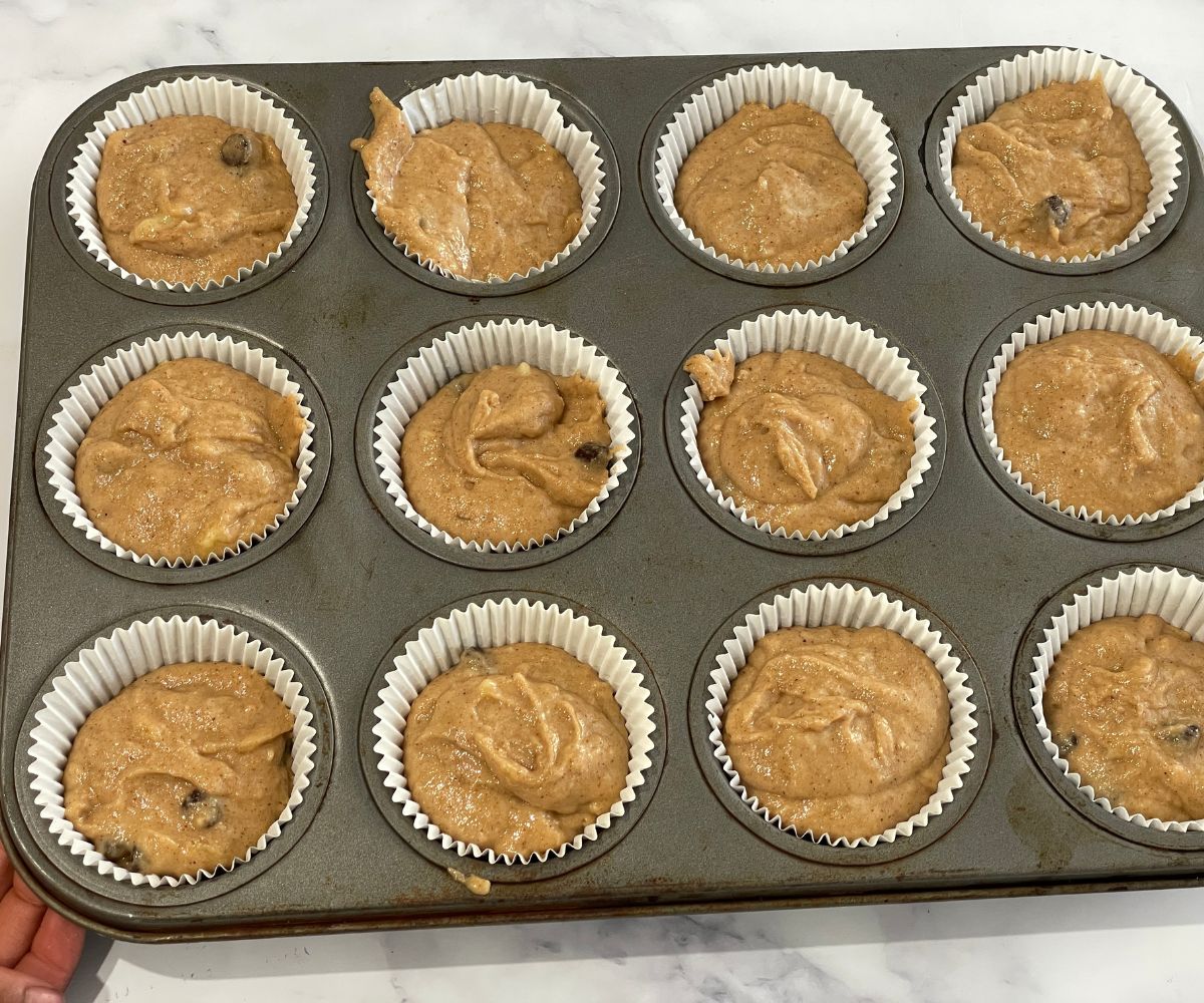 A muffin tray is filled with batter.