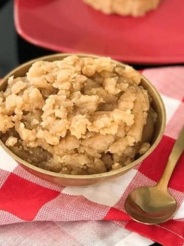 A copper bowl is with atta halwa.