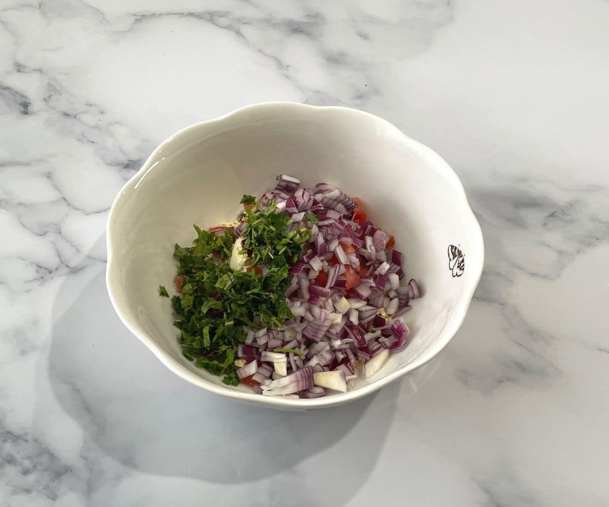 A bowl is with besan chilla mixture.