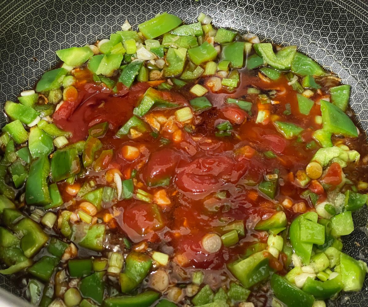 A pan is with Gobi Manchurian sauce over the heat.