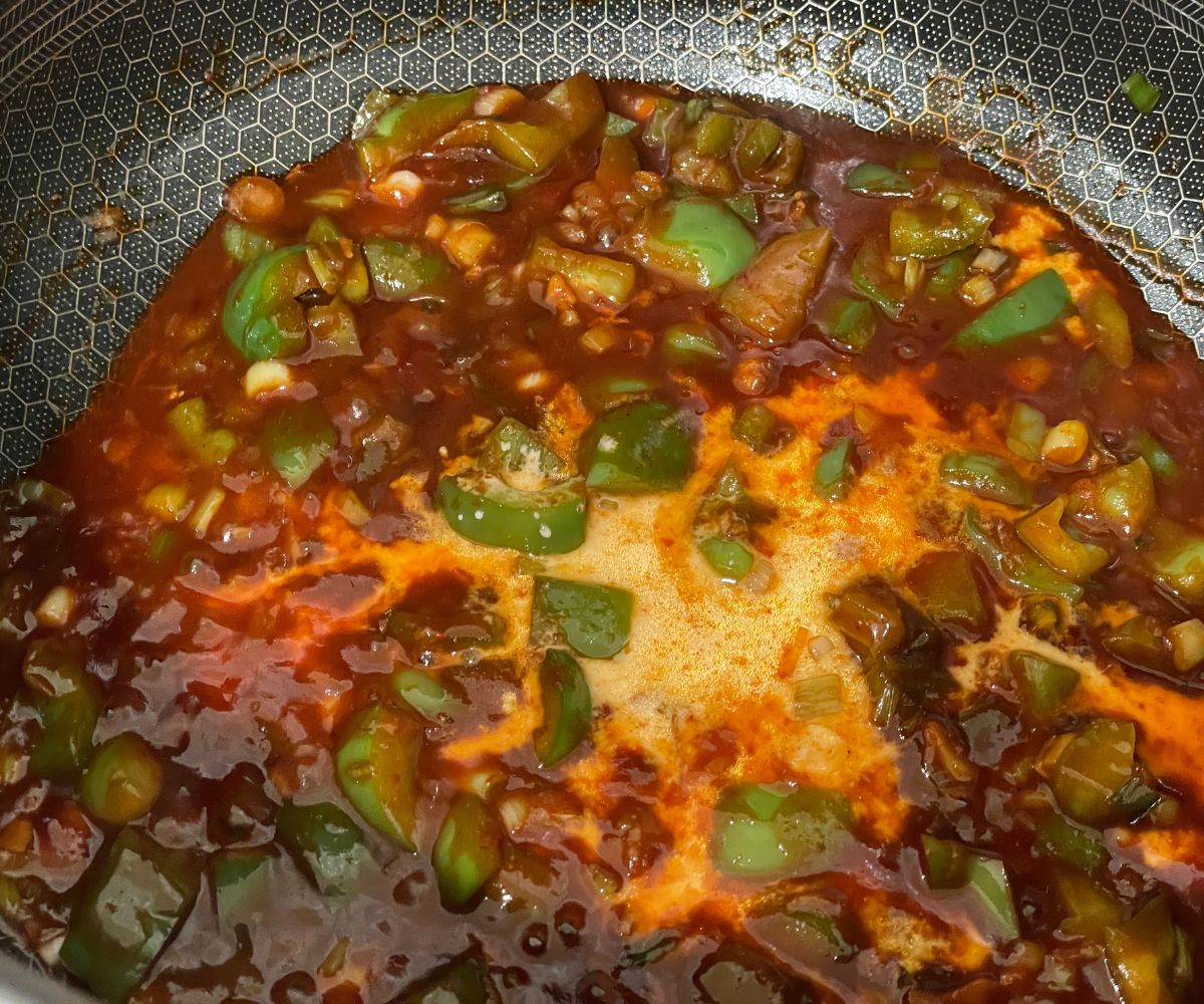 Gobi Manchurian sauce cooking over the stove top.