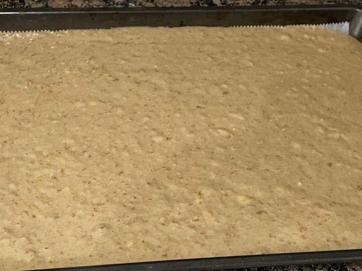 Vegan banana cake batter is inside the sheet pan