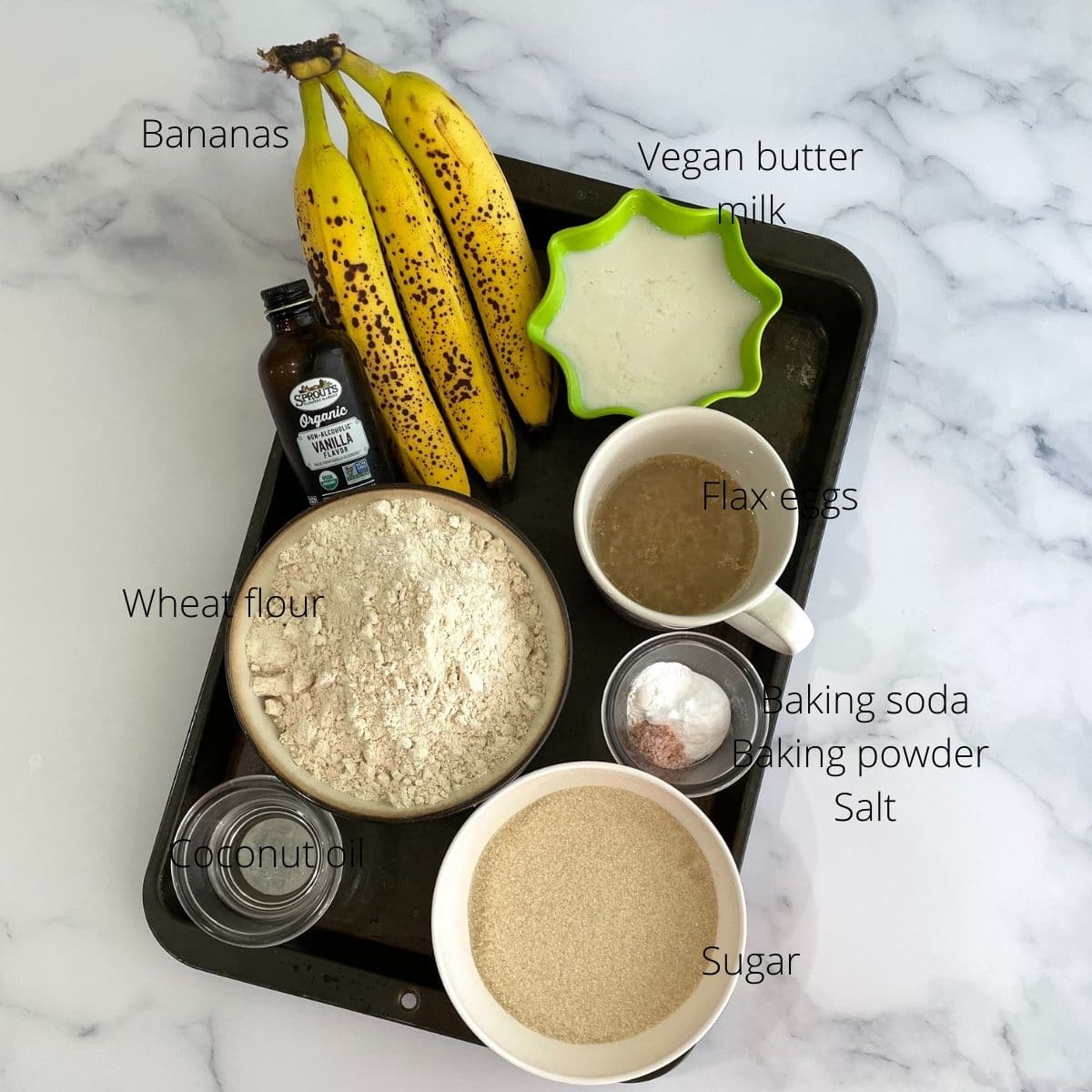 Baking tray is with banana cake ingredients like banana, oil, sugar, and baking powder.