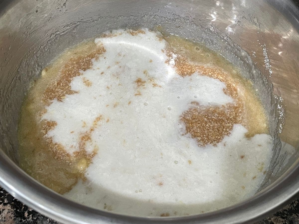 A big bowl is with wet ingredients like flax eggs and vegan butter milk 