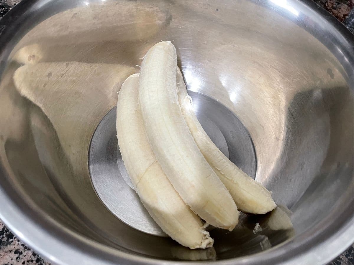 A big bowl is with peeled bananas