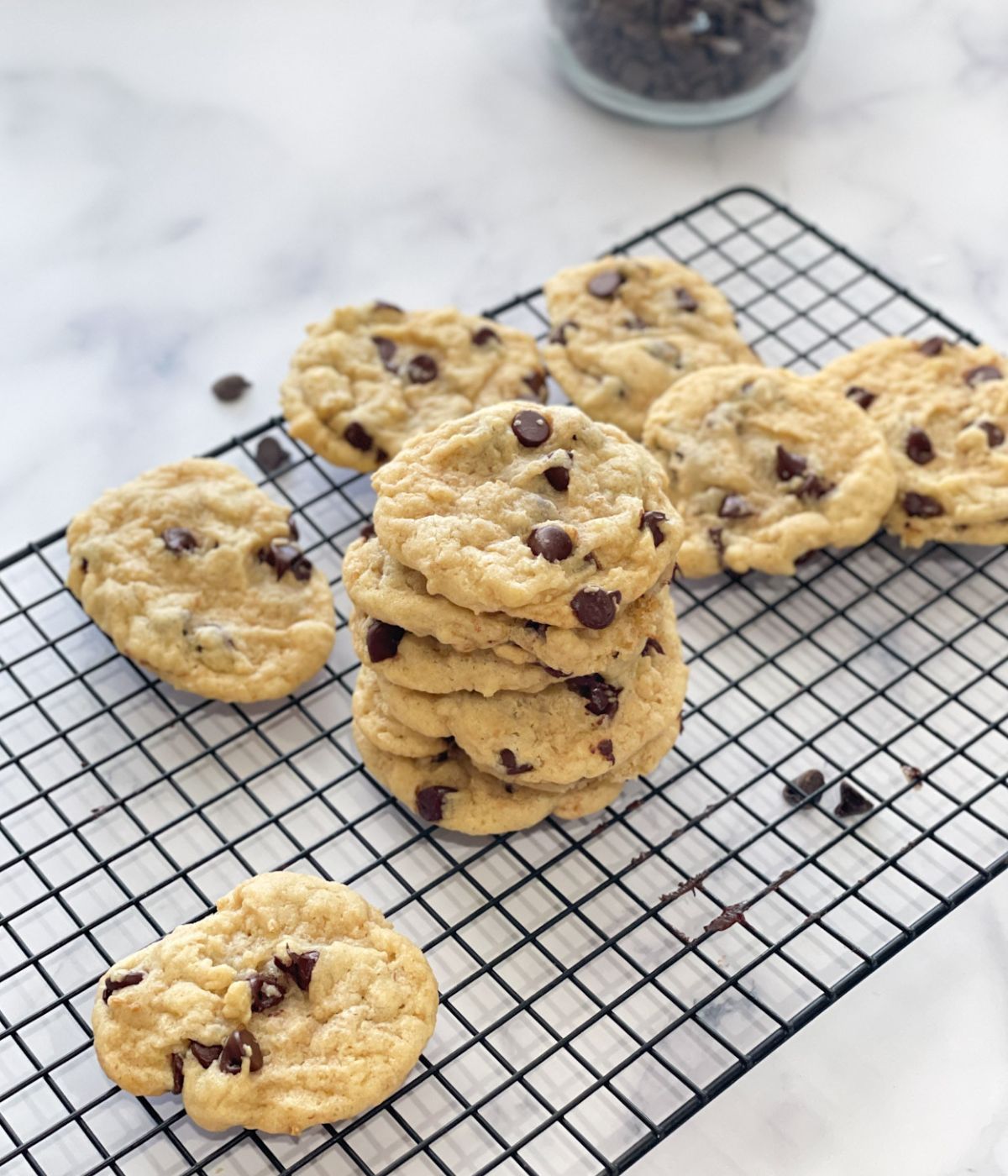 stack of chocolate chip cookies are on the rack.