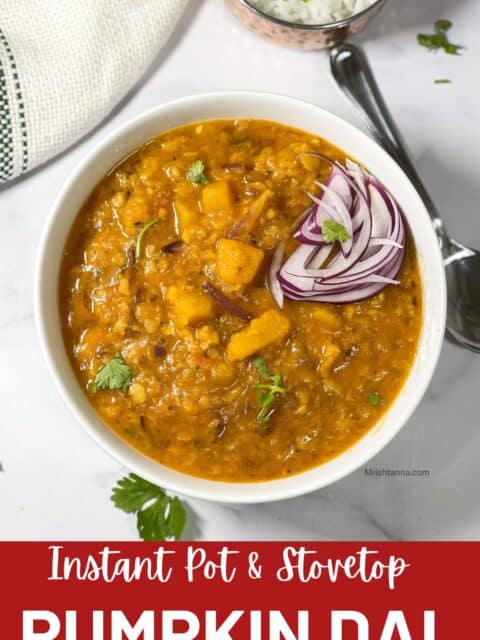 Pumpkin dal is poured into the bowl and topped with sliced onions.
