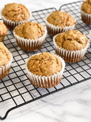 Banana Carrot muffins are placed on the cooling wire rack.