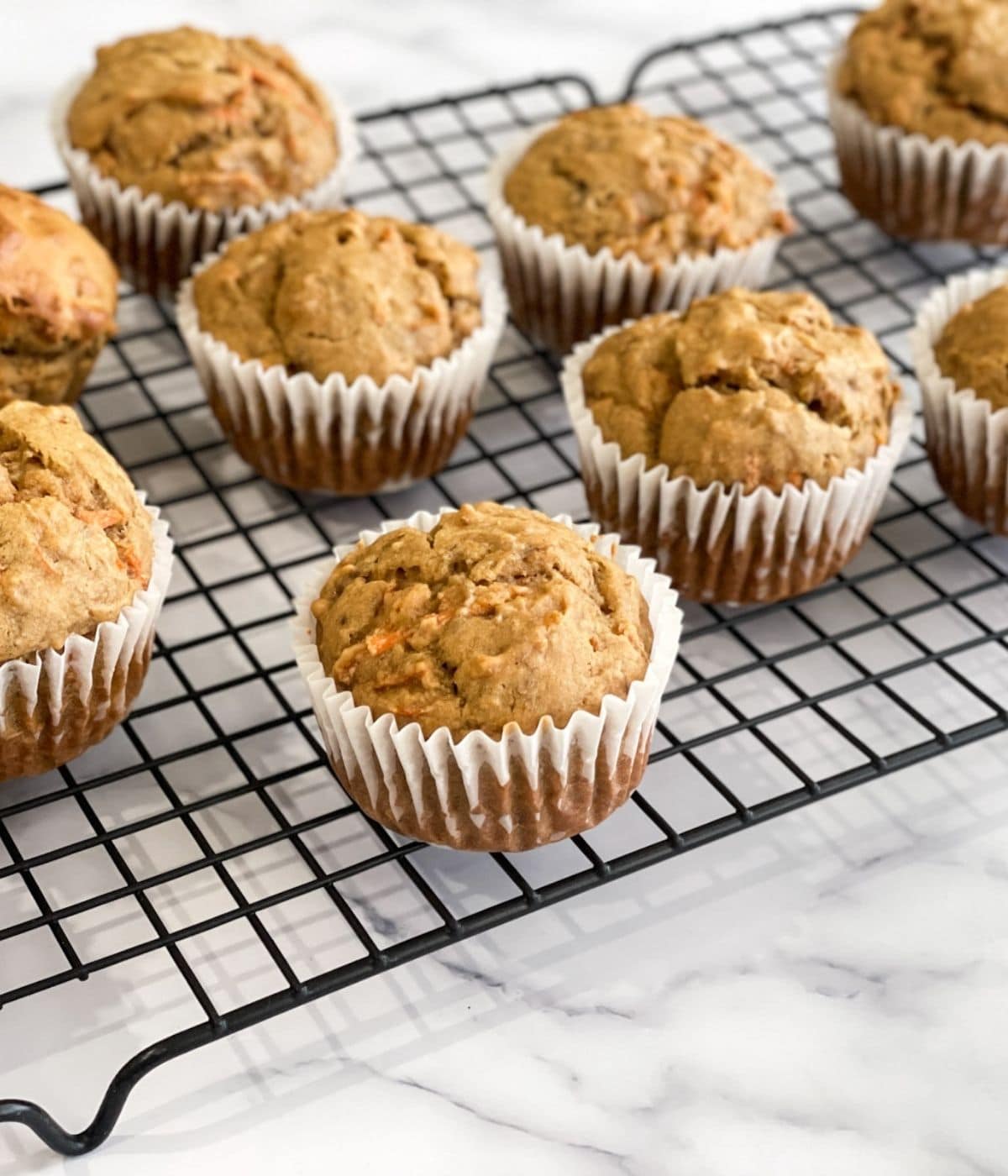 banana carrot muffins are on the cooling wire rack