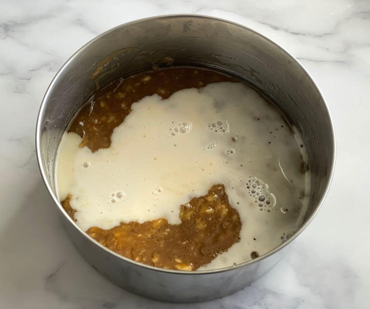 A bowl of wet ingredients with oil, dairy free milk.