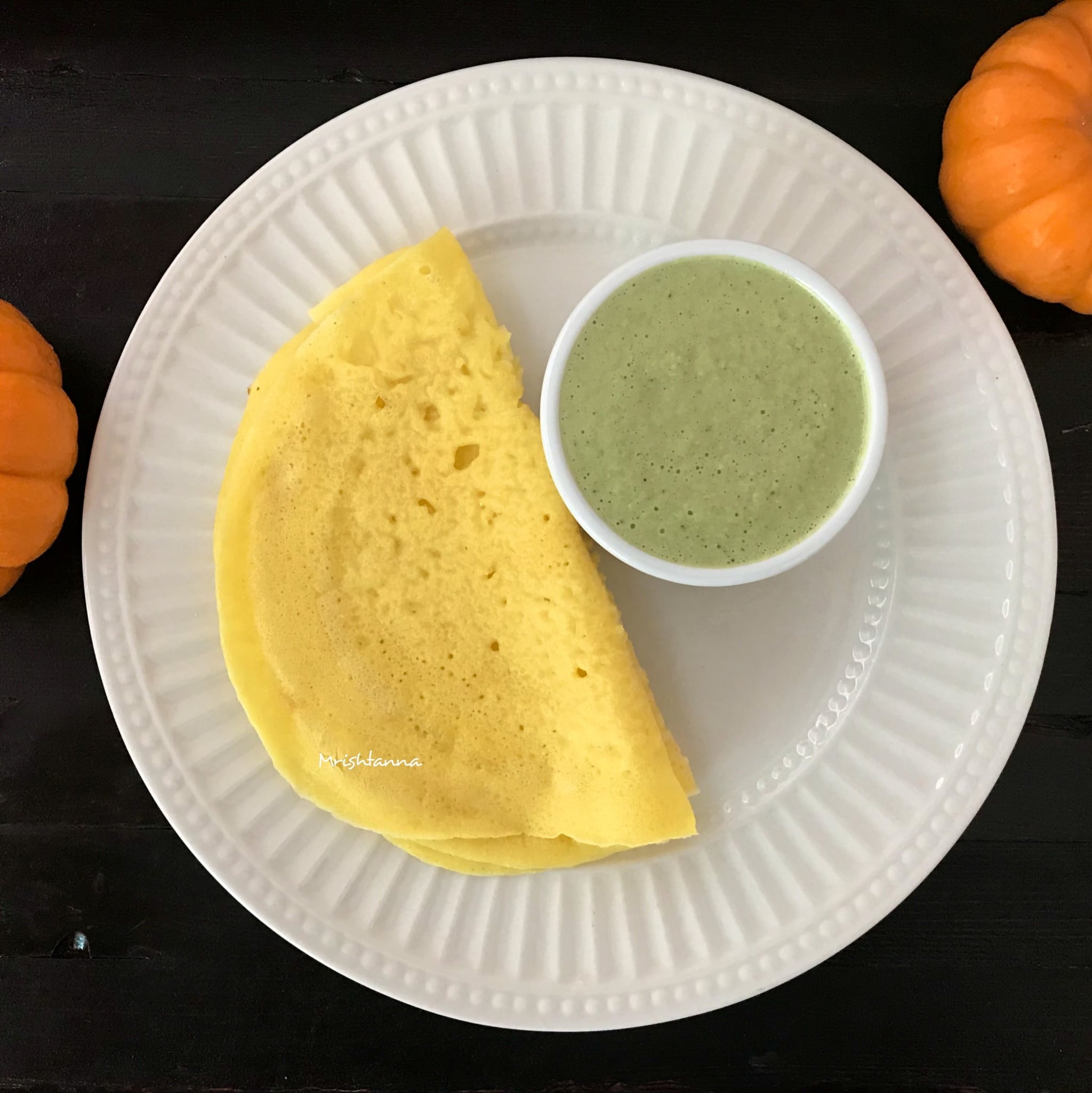 Fresh Pumpkin Dosa Pumpkin Dosa is on the plate along with coconut chutney