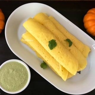 A plate of food on a table, with Pumpkin and Dosa