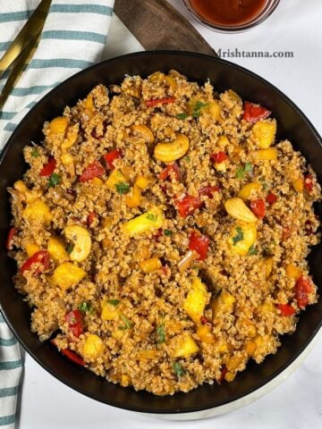 A plate of pineapple fried quinoa is on the table.