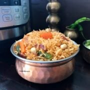 A bowl of food on a table, with Rice