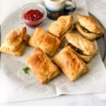 veg puff's are on the round baking tray with sauce.