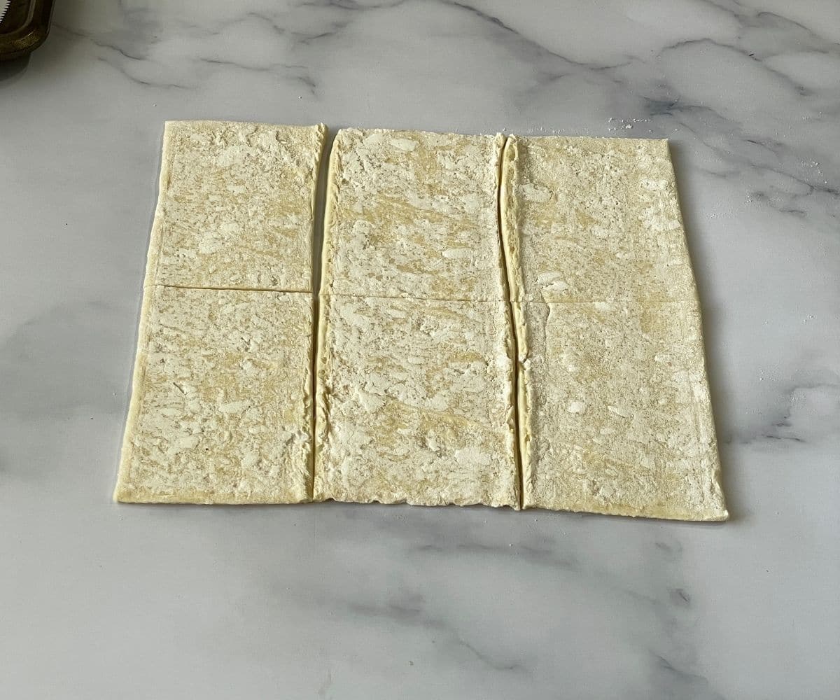 Puff pastry sheets are placed on the table.