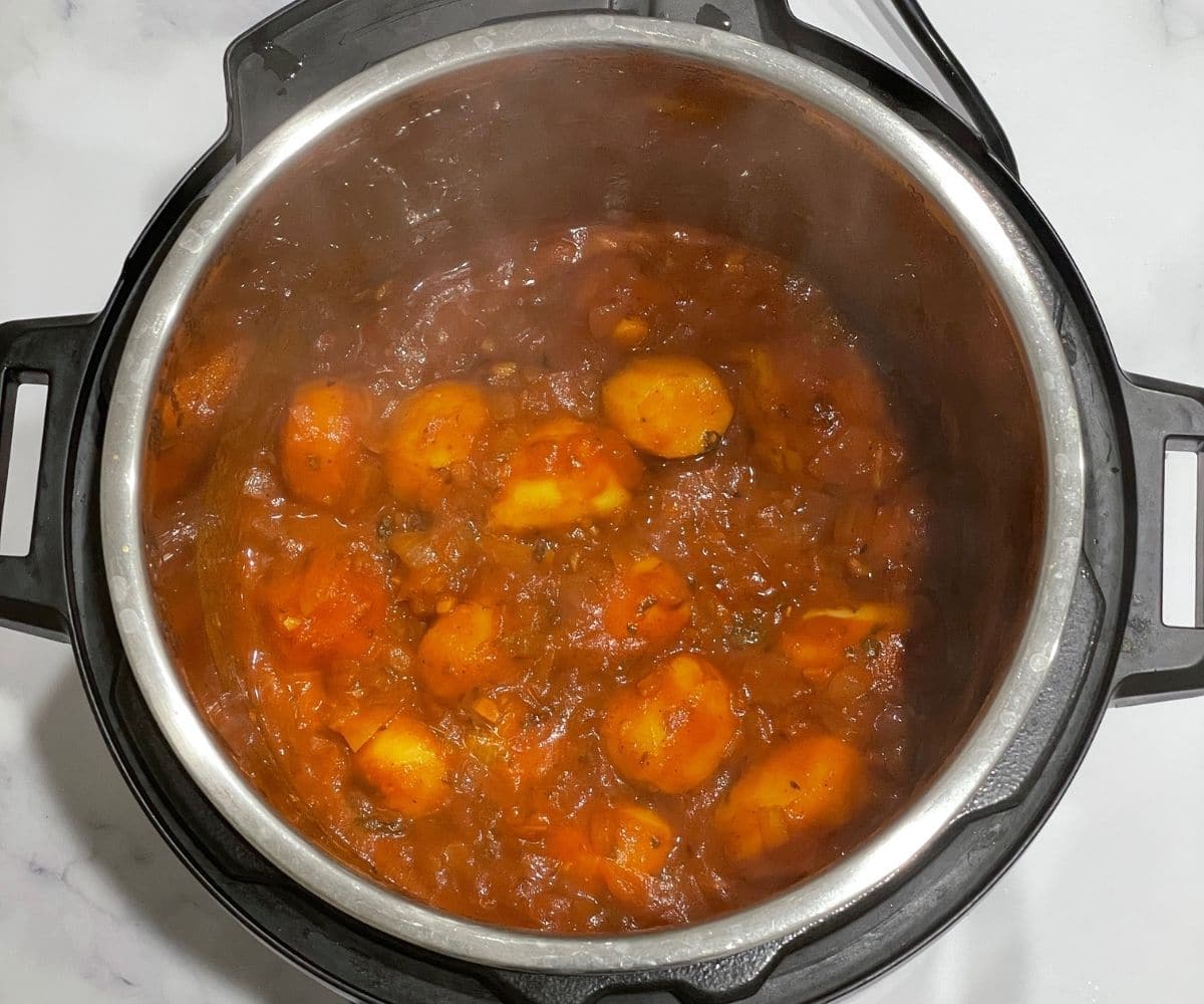 An instant pot dum aloo is on the table.