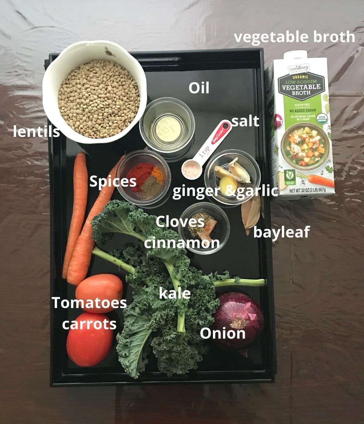 A tray is filled with all ingredients for lentil soup