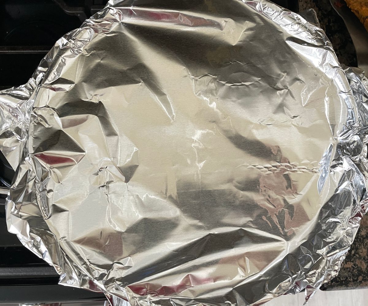 The pot is covered with aluminium foil.