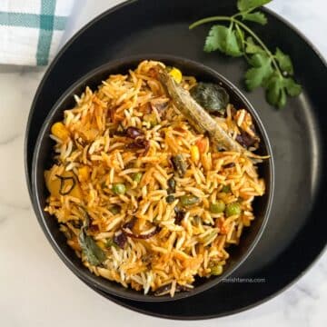 A bowl of Vegan dum biryani is on the plate.