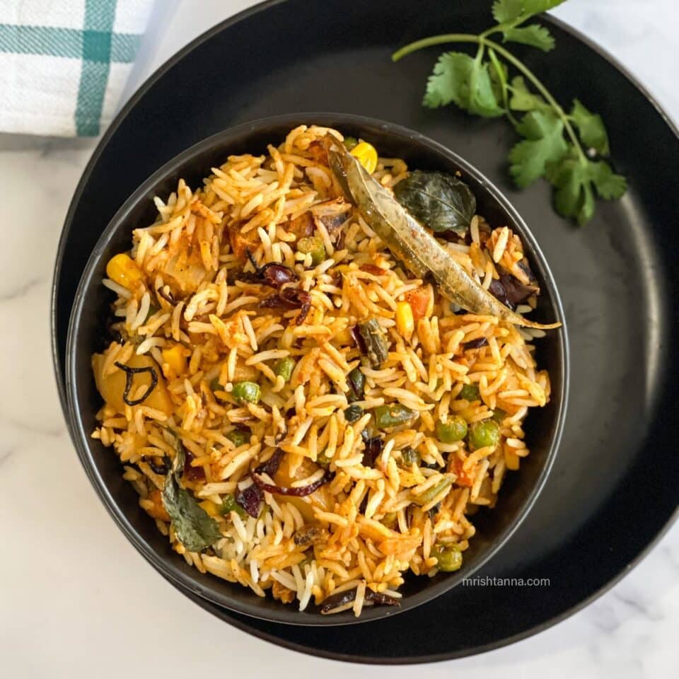 A bowl of Vegan dum biryani is on the plate.
