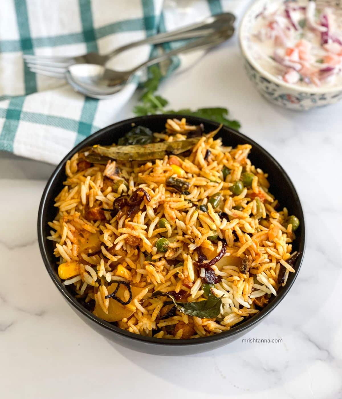 A bowl full of Vegan dum biryani.