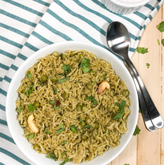 A bowl of food on a plate, with Pea and Rice