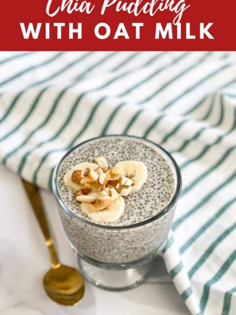 A glass bowl is with oat milk chia pudding and topped with banana and nuts.